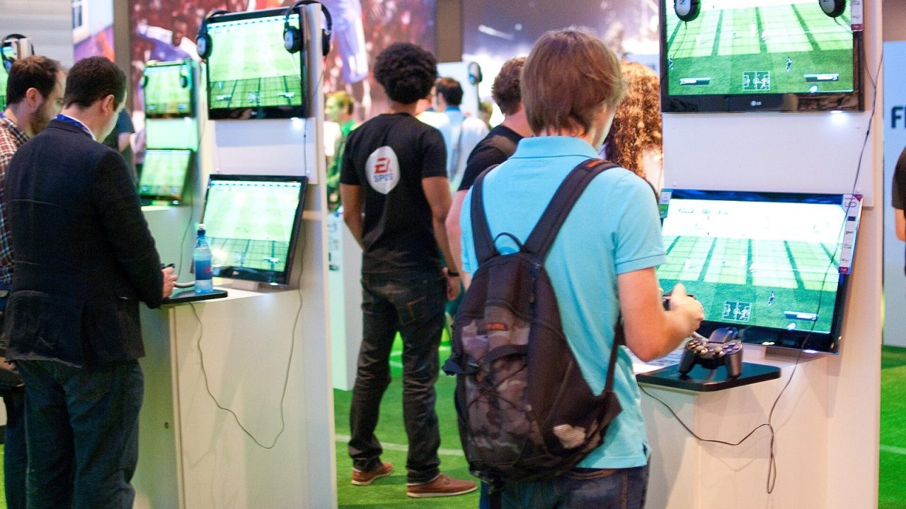 Visitors playing FIFA 12 at demo stations at Gamescom 2011 in Cologne