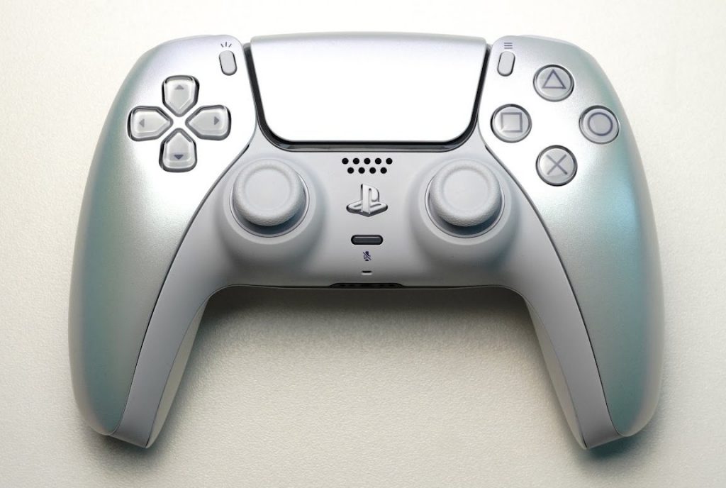 White and pearl PlayStation 5 DualSense controller on a plain background