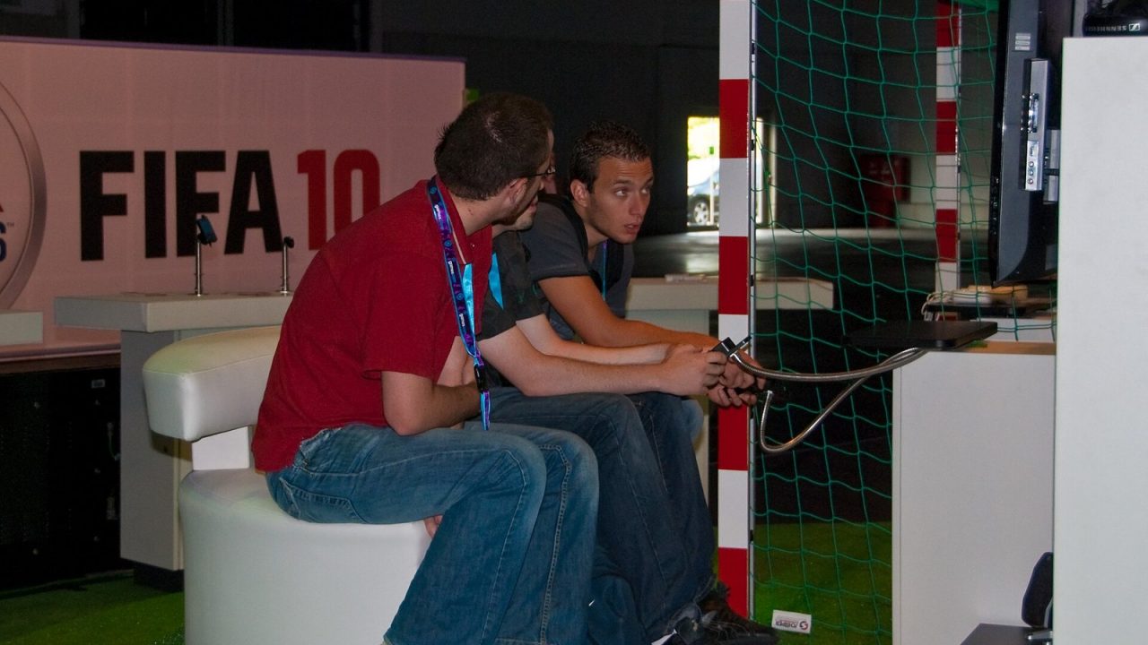 Visitors playing FIFA 10 at the EA stand at Gamescom 2009