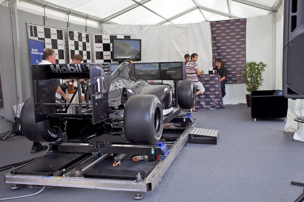 Formula 1 style racing simulator cockpit with a large screen at a Mobil 1 display