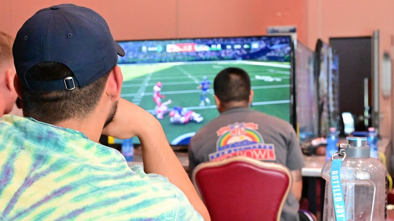 U.S. Air Force airmen competing in Madden NFL 21 while a spectator watches, Aviano Air Base 2023